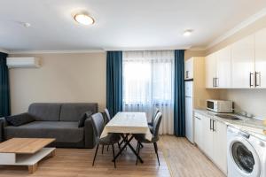 a living room with a couch and a table at Bissera premium apartments in Sofia