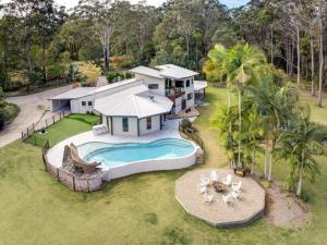 an aerial view of a house with a swimming pool at The Noosa Ranch- Where Nature meets Luxury in Tinbeerwah