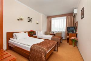 Postel nebo postele na pokoji v ubytování Conference Hotel Suputnyk