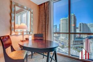 a room with a table and a large window at MGM Signature 15-603 Strip View Jacuzzi Studio in Las Vegas