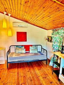 a bed in a room with a wooden ceiling at Romantic Private Cabin in Estepona