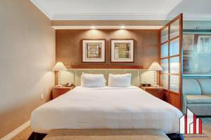 a hotel room with a large bed and a staircase at MGM Signature-28-816 Jacuzzi Studio in Las Vegas
