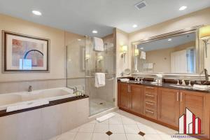a bathroom with a tub and a shower and a sink at MGM Signature-28-816 Jacuzzi Studio in Las Vegas