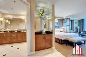 a hotel room with a bed and a bathroom at MGM Signature-28-816 Jacuzzi Studio in Las Vegas +69 photos