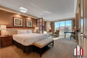 a hotel room with a large bed and a desk at MGM Signature-02-604 Jacuzzi Studio in Las Vegas