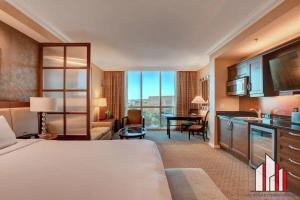 a large hotel room with a bed and a desk at MGM Signature-04-704 Jacuzzi Studio in Las Vegas +46 photos