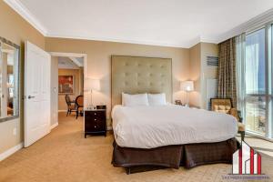 a bedroom with a large bed and a large window at MGM Signature-28-602 1Br 2Ba Balcony Jacuzzi Suite in Las Vegas +91 photos