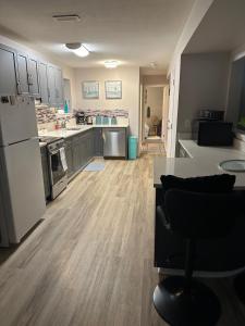 a large kitchen with a refrigerator and a counter at Pleasant Valley Vacation Suite in Nanaimo