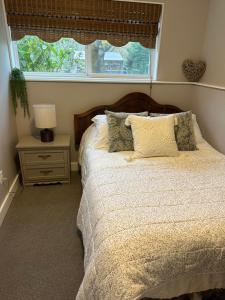 a bedroom with a large bed with a window at Pleasant Valley Vacation Suite in Nanaimo