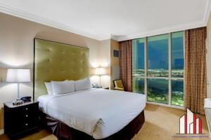 um quarto de hotel com uma cama grande e uma janela grande em MGM Signature-25-702 1Bedroom 2Bath Balcony Suite em Las Vegas