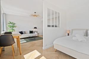 a bedroom with a bed and a table and a couch at Tranquil Retreat in the Vianden ID224 in Luxembourg