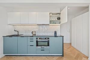 a kitchen with white cabinets and a sink at Tranquil Retreat in the Vianden ID224 in Luxembourg