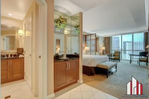 a bedroom with a bed and a bathroom with a view at MGM Signature-24-709 Strip View Jacuzzi Studio in Las Vegas