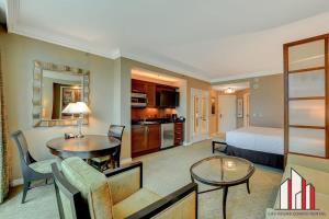 a hotel room with a bed and a living room at MGM Signature-24-709 Strip View Jacuzzi Studio in Las Vegas