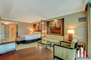 a hotel room with a bed and a living room at MGM Signature-24-709 Strip View Jacuzzi Studio in Las Vegas