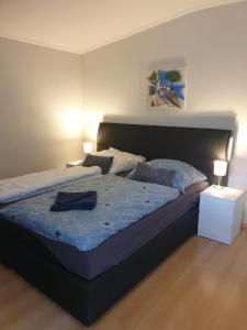 a bedroom with a large bed with a blue comforter at Erholung Pur bei Nina in Bad Lauterberg