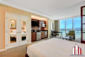 a hotel room with a large bed and a kitchen at MGM Signature-17-606 Jacuzzi Studio in Las Vegas