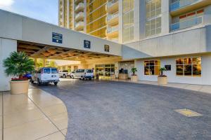 a large building with vehicles parked in a parking lot at MGM Signature-24-709 Strip View Jacuzzi Studio in Las Vegas