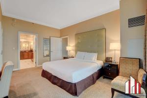 a large bedroom with a large bed and a chair at MGM Signature-29-602 1Br 2Ba Balcony Jacuzzi Suite in Las Vegas