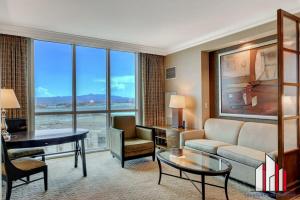 a living room with a couch and a table at MGM Signature-17-718 Jacuzzi Studio in Las Vegas
