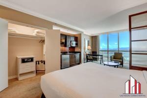 a hotel room with a large bed and a kitchen at MGM Signature-17-718 Jacuzzi Studio in Las Vegas +41 photos