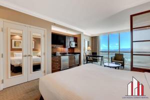 a hotel room with a large bed and a kitchen at MGM Signature-17-718 Jacuzzi Studio in Las Vegas