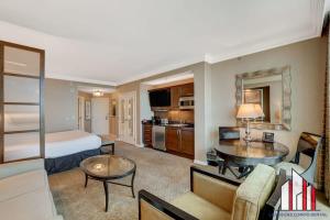 a hotel room with a bed and a living room at MGM Signature-17-718 Jacuzzi Studio in Las Vegas