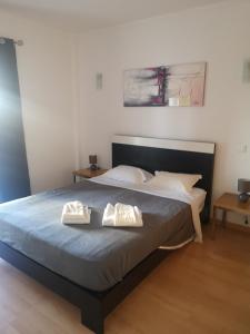 a bedroom with a bed with two towels on it at Rocha T Apartments in Portimão