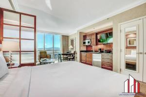 a large bedroom with a large bed and a kitchen at MGM Signature-15-604 Jacuzzi Studio in Las Vegas