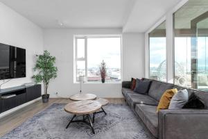 a living room with a couch and a table at Spacious Luxury 3BR Apartment with 2 bathrooms 1003 in Reykjavík