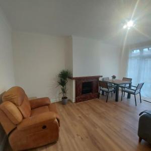 a living room with a couch and a table at Jemima Place semi-detached hse. in Wallington