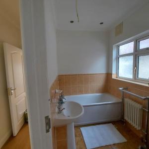 a bathroom with a sink and a bath tub at Jemima Place semi-detached hse. in Wallington