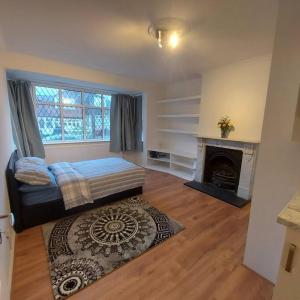 a bedroom with a bed and a fireplace at Jemima Place semi-detached hse. in Wallington