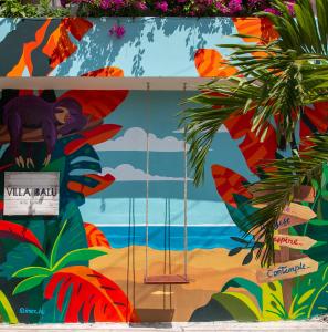 a mural of a woman on the beach at Hotel Boutique Villa Balu in Bacalar