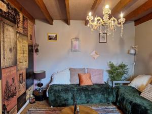 a bedroom with a bed and a chandelier at Gite Fée Grenouille in Martigny-le-Comte