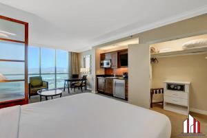 a hotel room with a large bed and a kitchen at MGM Signature-24-716 Jacuzzi Studio in Las Vegas