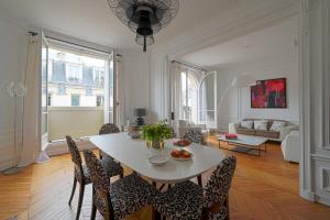 a living room with a white table and chairs at Luxury apartment at Auteuil in Paris