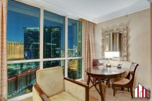 a room with a table and a large window at MGM Signature-20-609 Strip View Jacuzzi Studio in Las Vegas