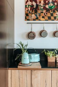 a shelf with a pot on top of a wooden cabinet at Superbe Villa avec piscine intérieure chauffée in Bonneville-sur-Touques