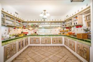 a large kitchen with lots of counters and shelves at Hotel Piroska in Bük