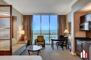 a living room with a couch and a table in a room at MGM Signature-31-704 Jacuzzi Studio in Las Vegas