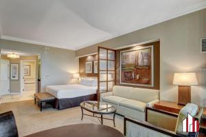a hotel room with a bed and a couch at MGM Signature-31-704 Jacuzzi Studio in Las Vegas +38 photos