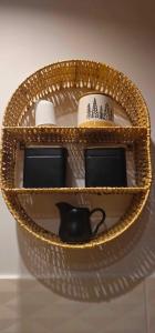a wicker basket with a black tea pot in it at Domki Dwa jelonki - balia z jacuzzi i sauna in Wisła