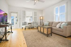 a living room with a couch and a piano at Beach Cottage! 100 Steps to the Sand, Pets OK, Private Deck! in Saint Augustine