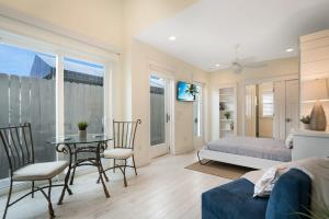 a bedroom with a bed and a table and chairs at Mod Studio - 100 Steps to the Beach, Pets OK, Private Deck! in St. Augustine