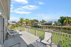 a porch with chairs and a view of a river at Canal Front Home! Walk to Beach, Porch, Fishing in St. Augustine