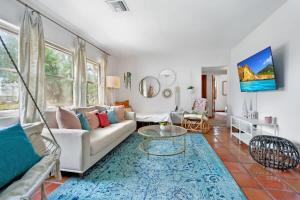 a living room with a couch and a table at Pink House Prime Location Walk to Downtown Dogs OK in Saint Augustine