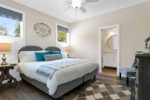 a bedroom with a bed and a clock on the wall at Blue House, Prime Location, Family Amenities, BBQ! in Saint Augustine