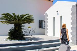a woman walking down the stairs with a suitcase at Dreamscape Villa in Ponta Delgada