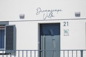 a sign on the side of a building with a door at Dreamscape Villa in Ponta Delgada